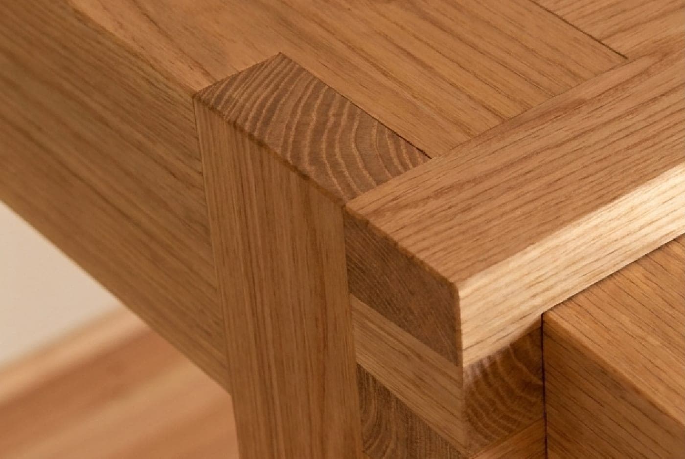 Close-up of a hand-cut wooden joint, fitted seamlessly by reading the grain of each timber